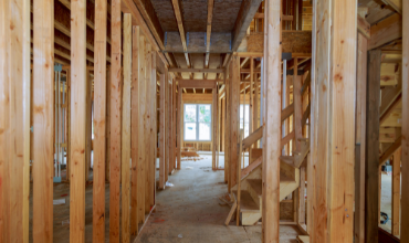 Custom home builders constructing a house with wooden framing in Hickory, NC.